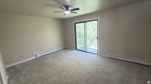 647 Swenson Avenue, Unit 4 Springville, UT 84663 - Photo 7 of 14 Bed 1. Carpeted spare room featuring baseboard heating, a textured ceiling, and ceiling fan