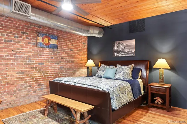 a bed sitting in a bedroom next to a lamp