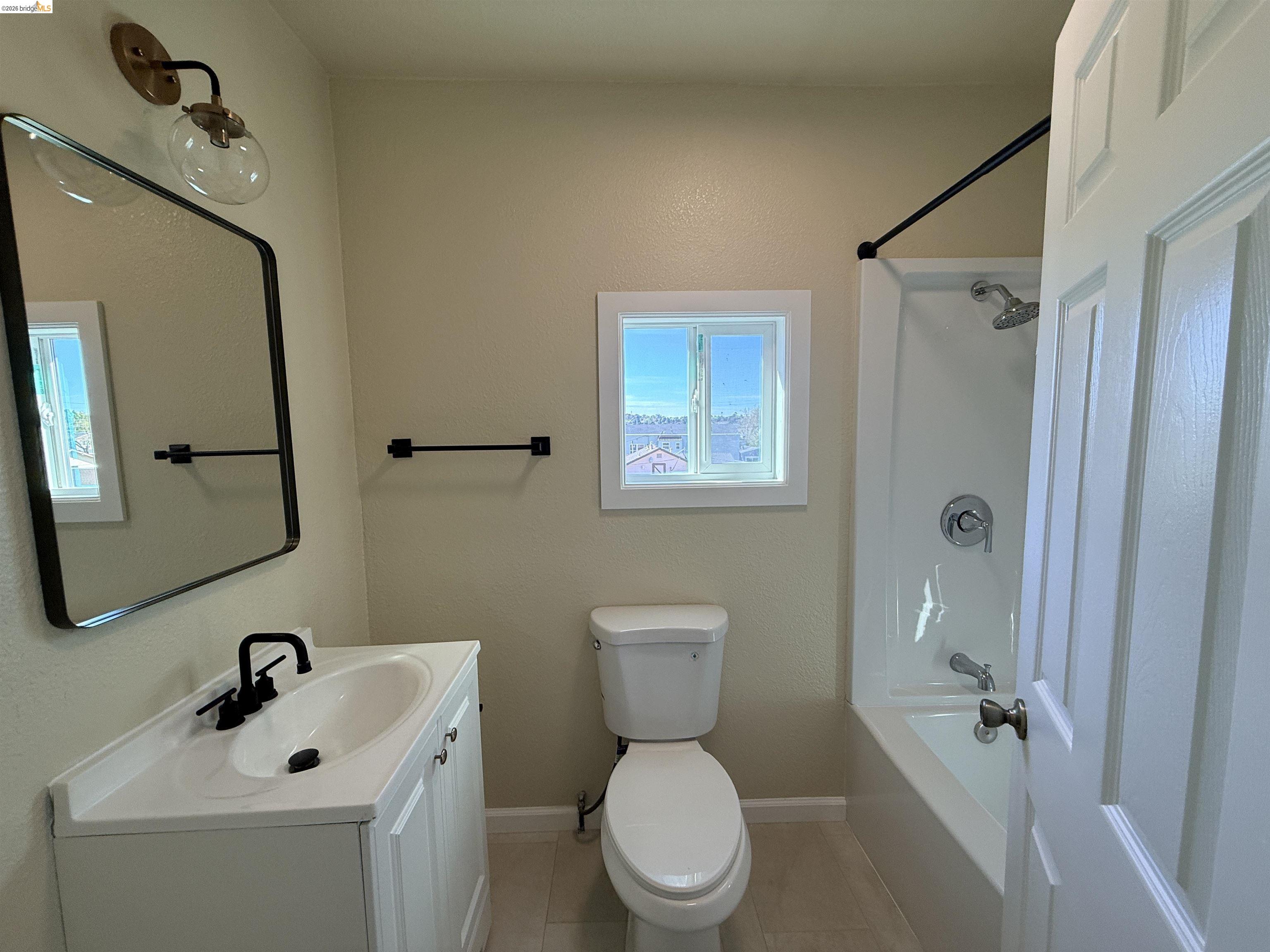 321 Benicia Road Vallejo, CA 94590 - Photo 13 of 48 Bathroom with vanity, bathing tub / shower combination, and light tile patterned flooring