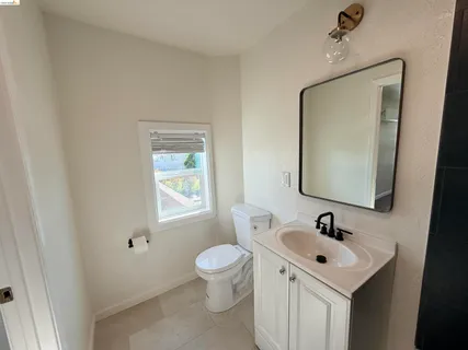 a bathroom with a sink mirror and toilet