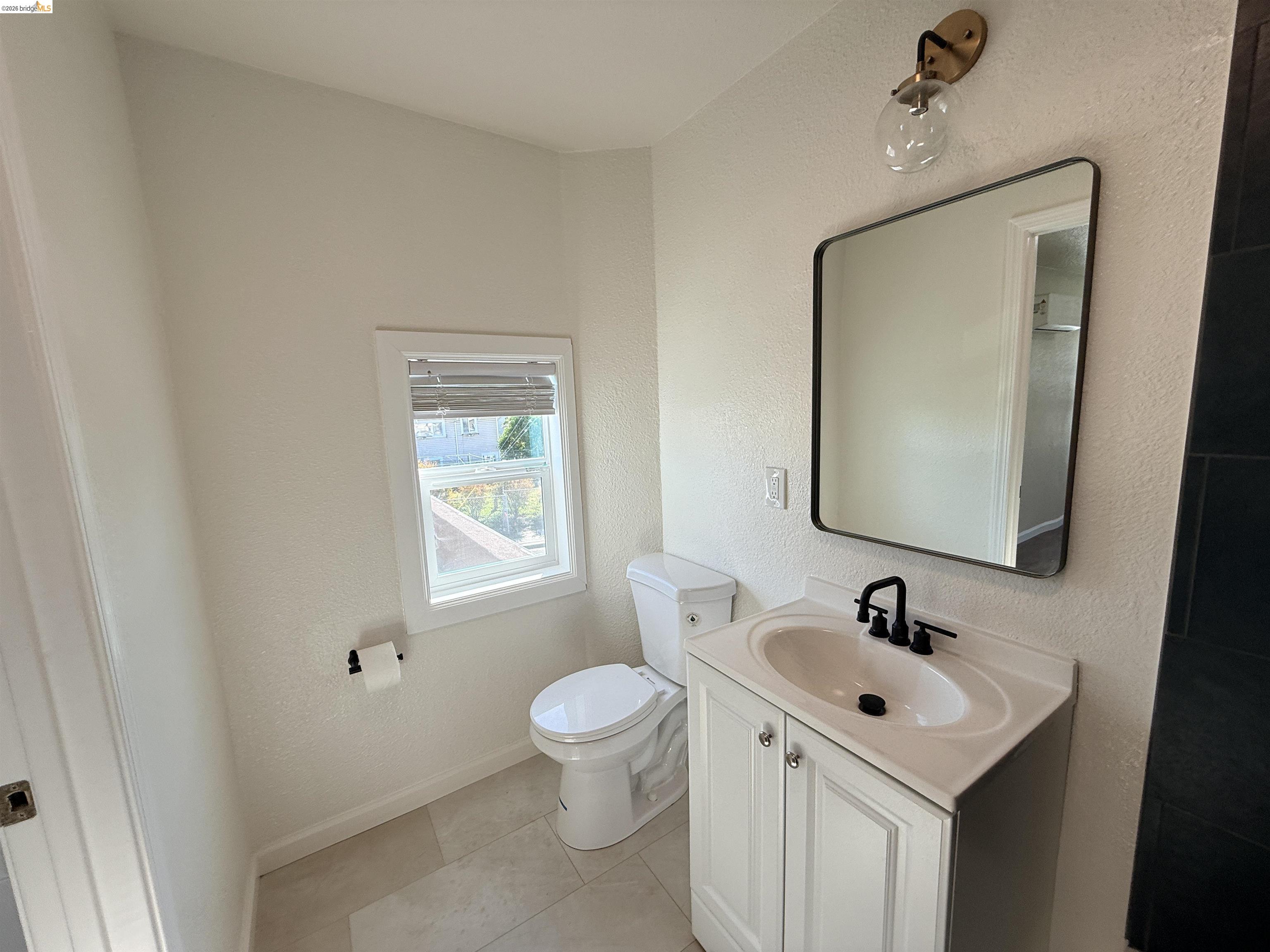 321 Benicia Road Vallejo, CA 94590 - Photo 14 of 48 Bathroom featuring vanity, a textured wall, and light tile patterned floors
