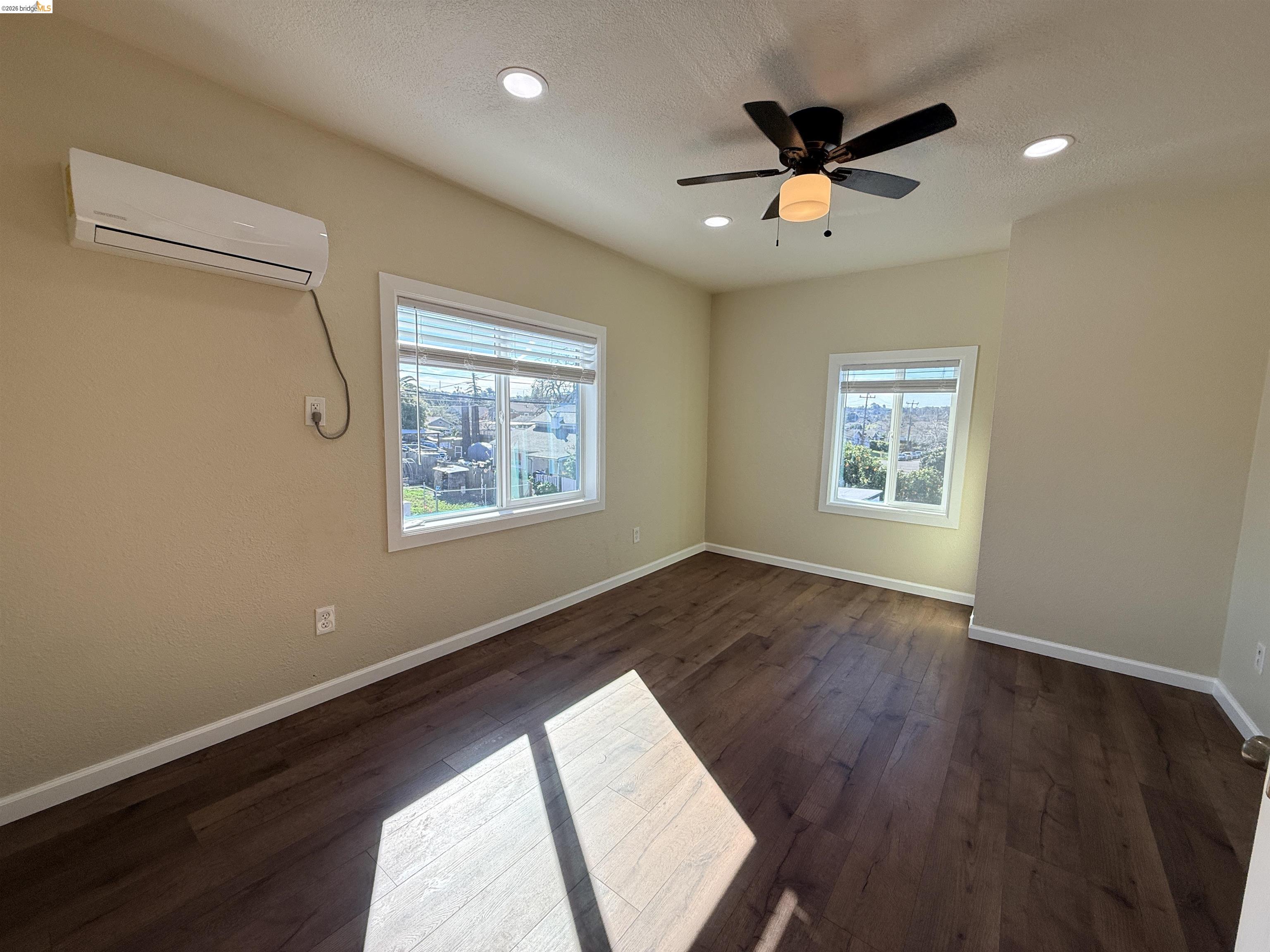 321 Benicia Road Vallejo, CA 94590 - Photo 15 of 48 Spare room featuring a ceiling fan, dark wood-style floors, healthy amount of natural light, and recessed lighting