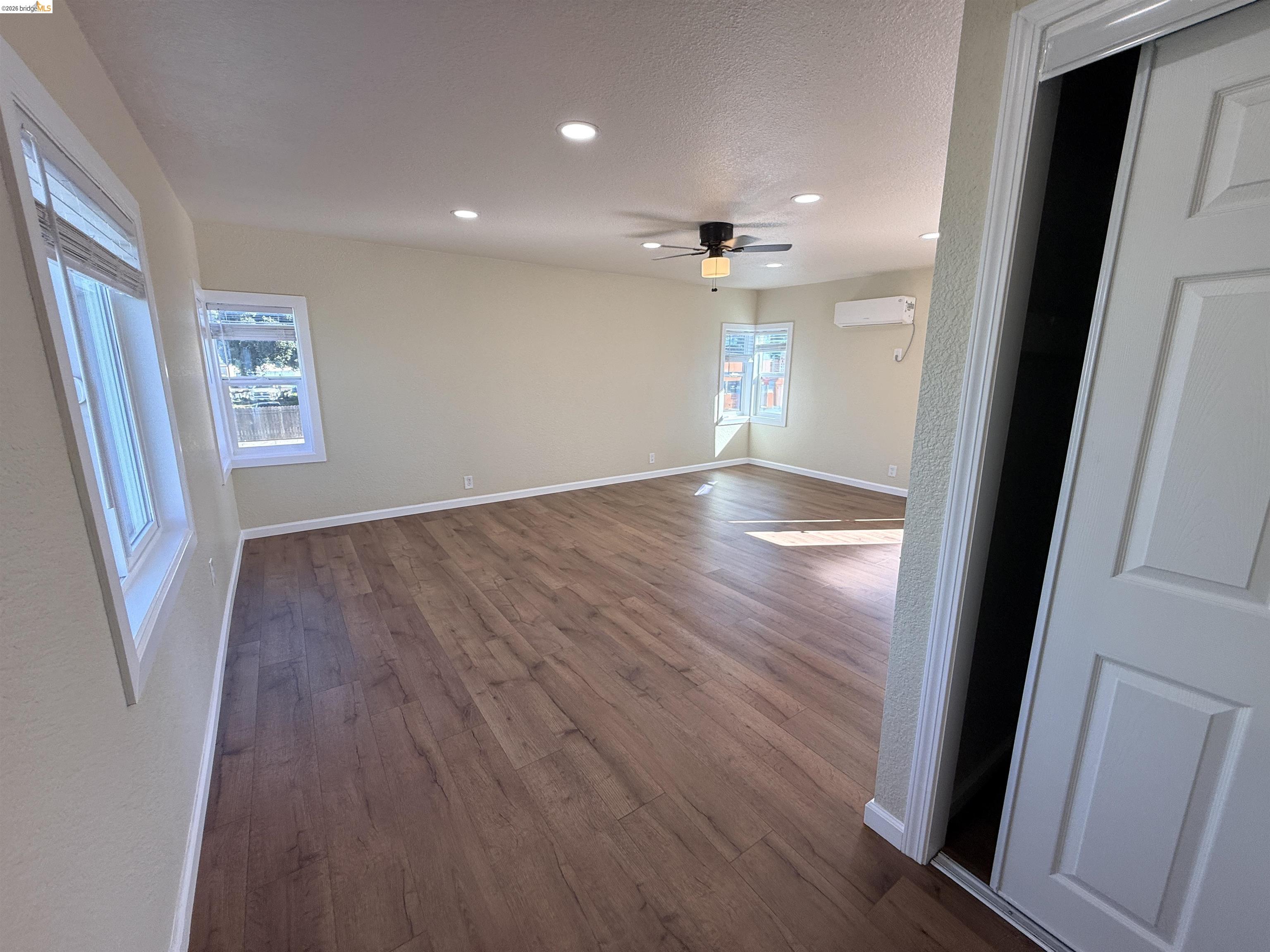 321 Benicia Road Vallejo, CA 94590 - Photo 22 of 48 Empty room with dark wood-style floors, recessed lighting, a ceiling fan, and a textured ceiling
