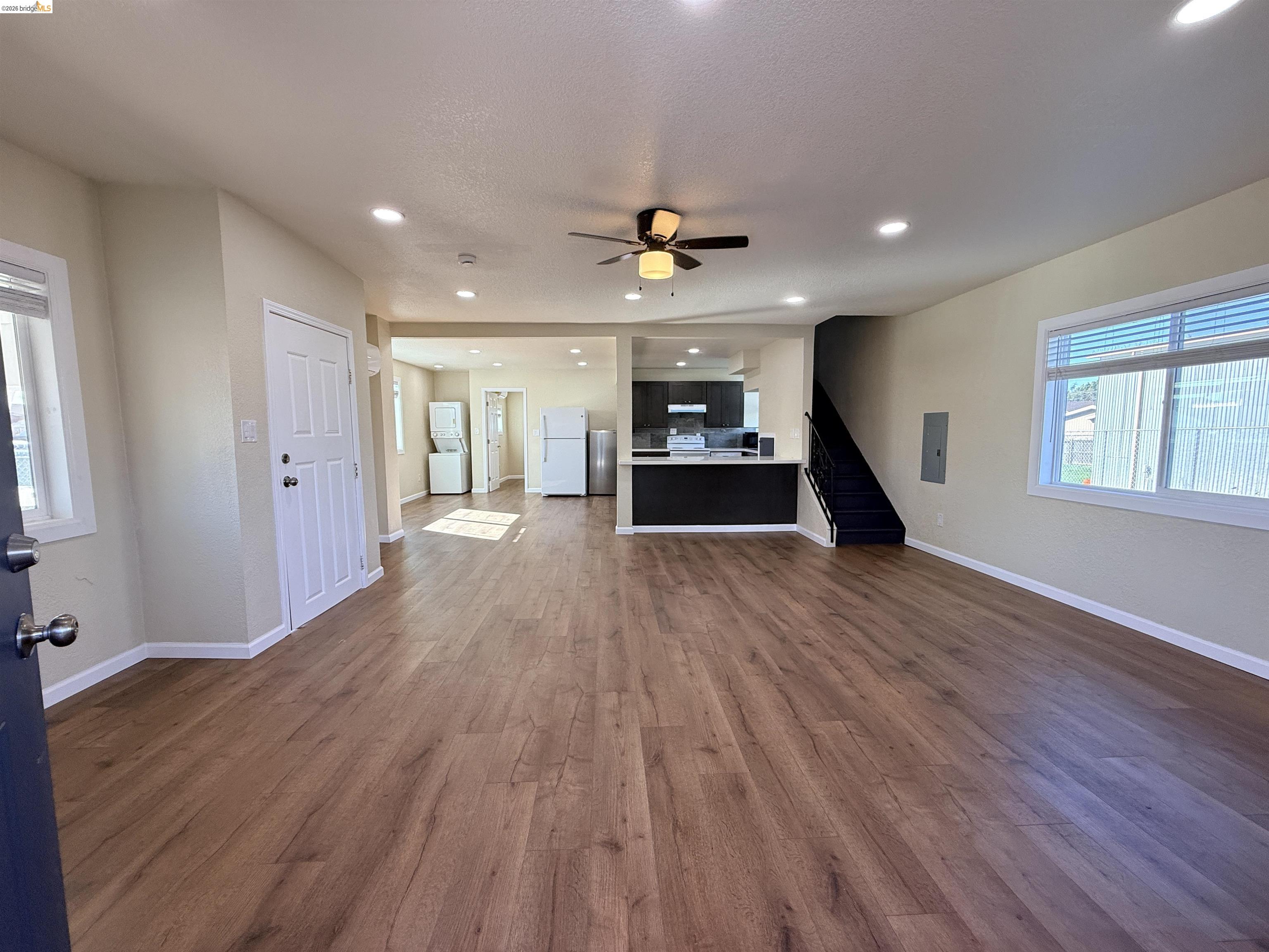321 Benicia Road Vallejo, CA 94590 - Photo 4 of 48 Unfurnished living room with recessed lighting, dark wood-style floors, a ceiling fan, electric panel, and washer / dryer