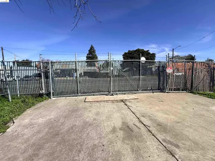 a view of backyard of house and car parked