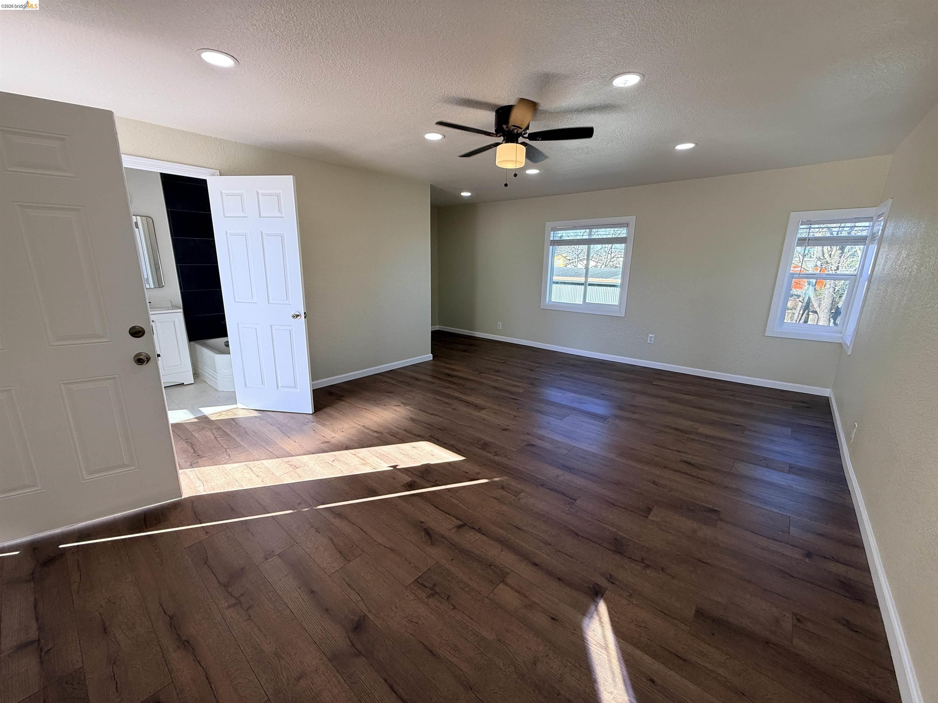 321 Benicia Road Vallejo, CA 94590 - Photo 5 of 48 Spare room featuring dark wood finished floors, a ceiling fan, a textured ceiling, and recessed lighting
