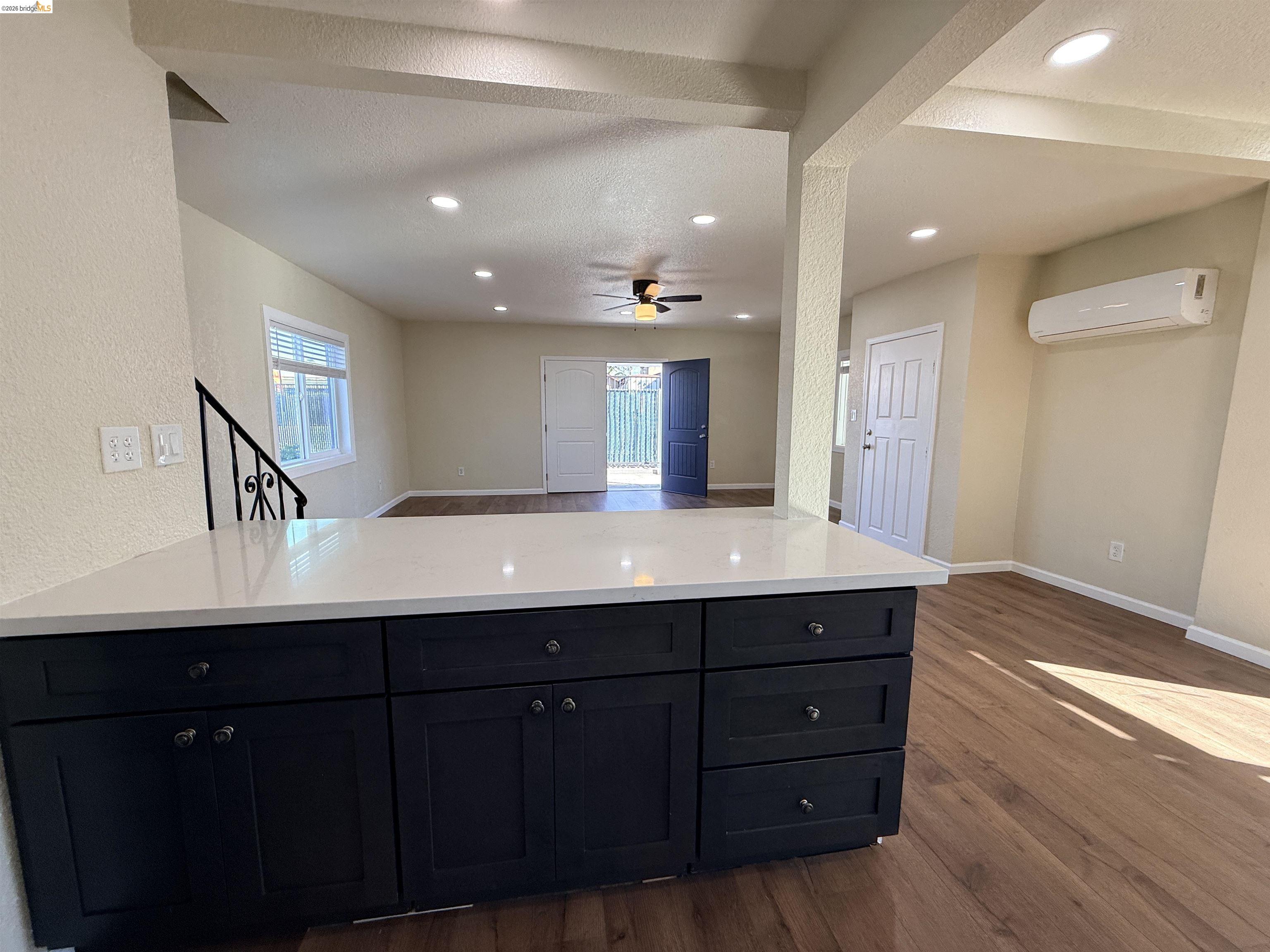 321 Benicia Road Vallejo, CA 94590 - Photo 48 of 48 Kitchen featuring open floor plan, dark wood finished floors, dark cabinetry, a textured ceiling, and recessed lighting
