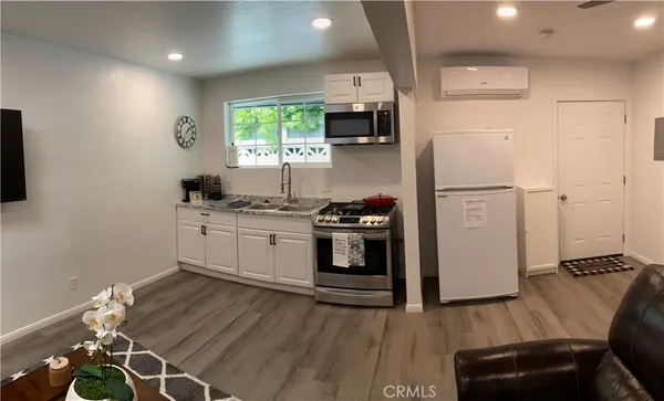 a kitchen with a sink appliances and cabinets