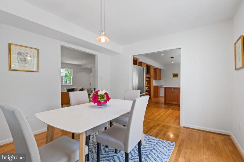 6701 Fairfax Road, Unit 76 Chevy Chase, MD 20815 - Photo 14 of 42 a view of a dining room with furniture and wooden floor