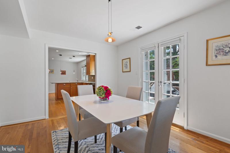 6701 Fairfax Road, Unit 76 Chevy Chase, MD 20815 - Photo 15 of 42 a view of a dining room with furniture and wooden floor