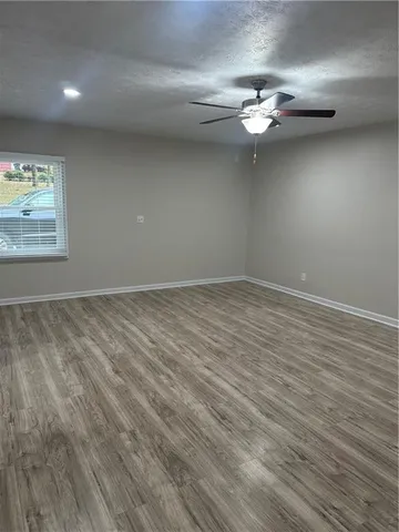 a view of a room with wooden floor