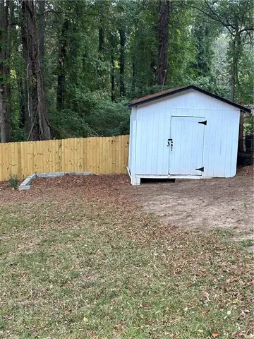 a view of backyard with wooden fence