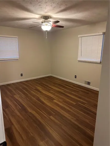 a view of a room with wooden floor