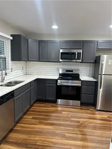 a kitchen with a sink stove and refrigerator