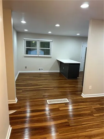 a view of room with wooden floor