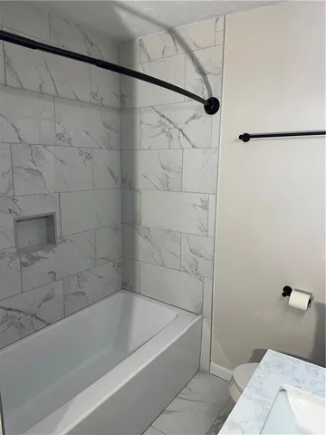 a bathroom with a bathtub and shower