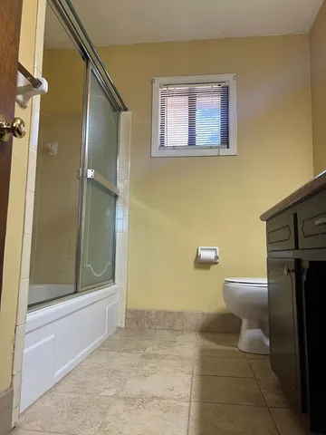 a bathroom with a toilet and a shower