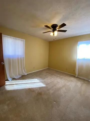 an empty room with a empty space and a ceiling fan