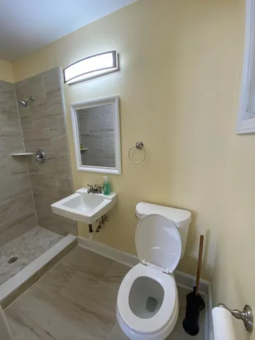 a white toilet sitting next to a bathroom sink