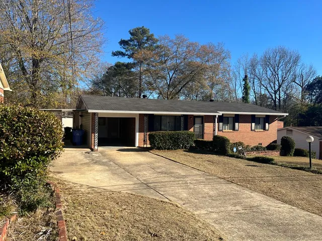 a front view of a house with a yard covered with snow in front of house