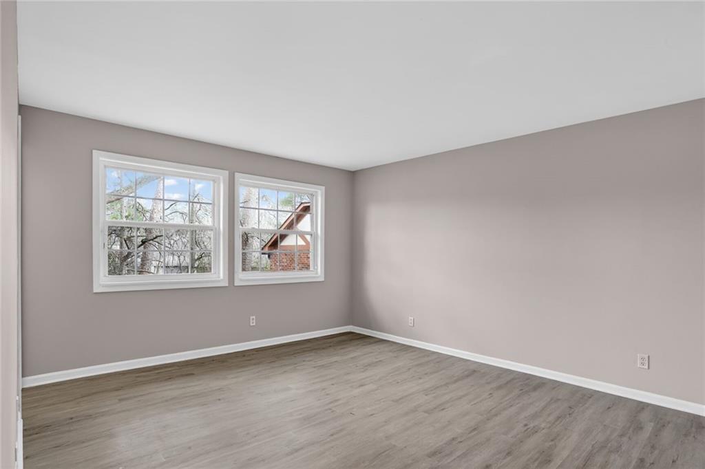 2825 Northeast Expressway, Unit J3 Atlanta, GA 30345 - Photo 15 of 23 an empty room with wooden floor and windows