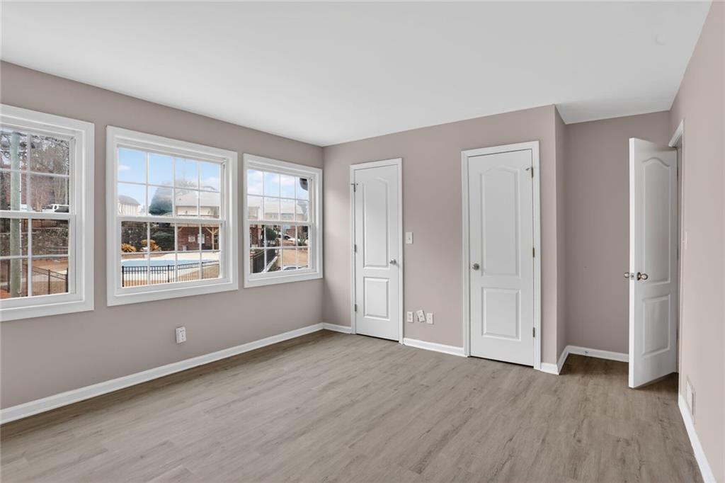 2825 Northeast Expressway, Unit J3 Atlanta, GA 30345 - Photo 20 of 23 a view of an empty room with a window and wooden floor