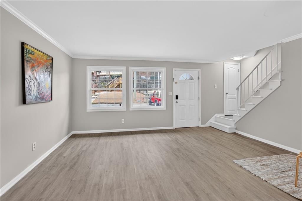 2825 Northeast Expressway, Unit J3 Atlanta, GA 30345 - Photo 5 of 23 a view of an empty room with wooden floor and window