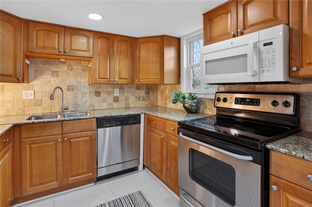2825 Northeast Expressway, Unit J3 Atlanta, GA 30345 - Photo 9 of 23 a kitchen with stainless steel appliances granite countertop a stove a sink and a microwave