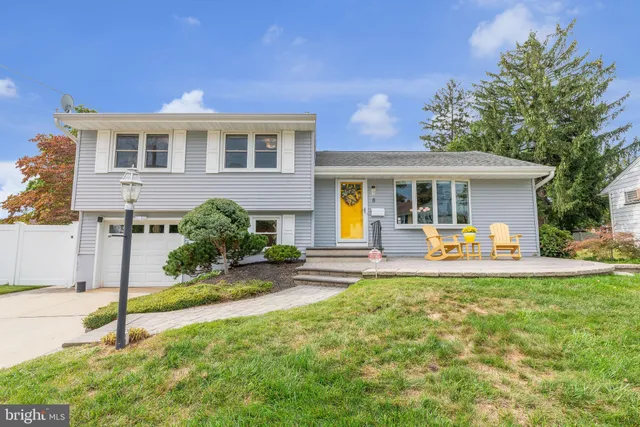 a front view of a house with swimming pool and porch