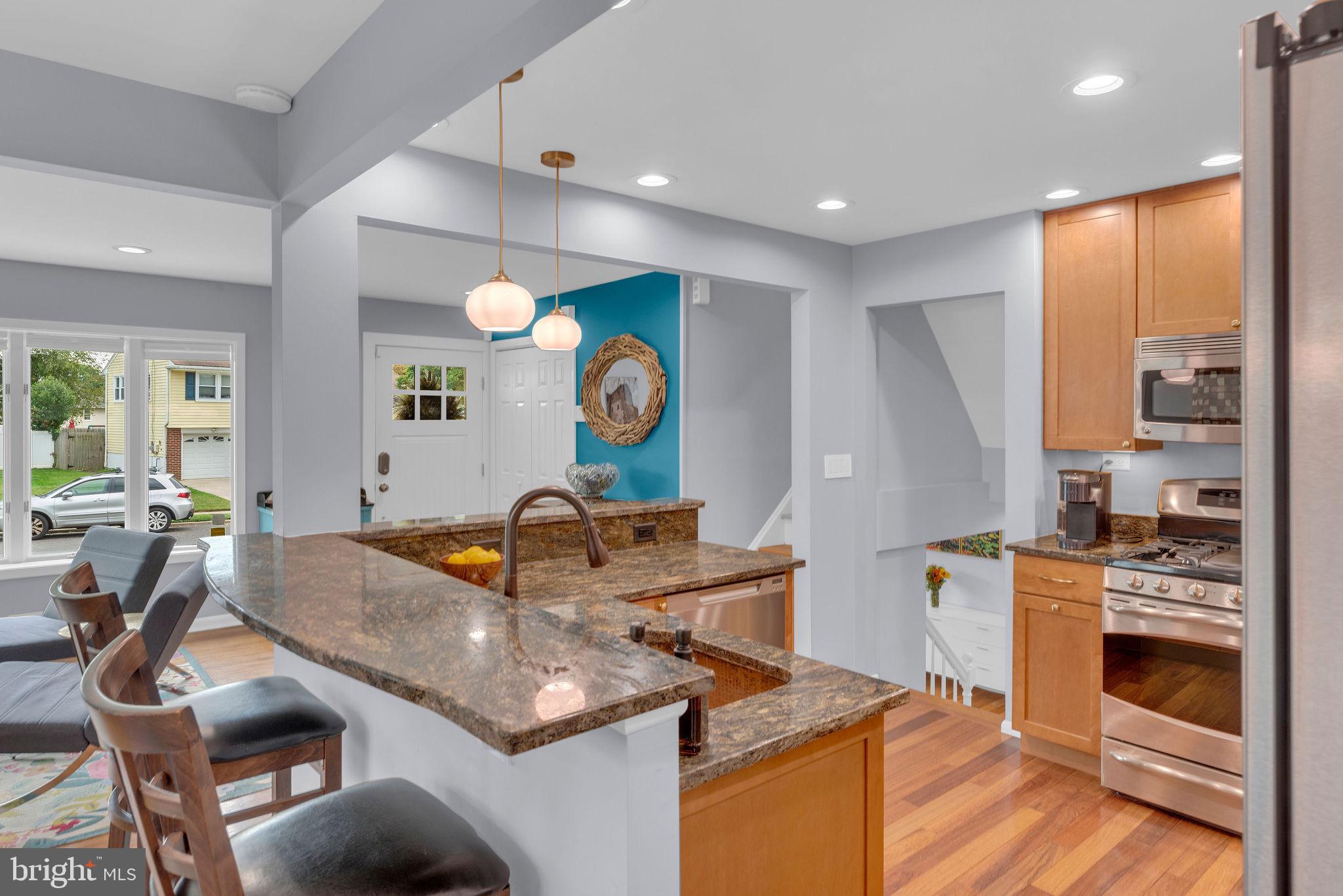 8 Dailey Drive Hamilton, NJ 08620 - Photo 13 of 46 a kitchen with stainless steel appliances granite countertop a sink a stove and a wooden floors