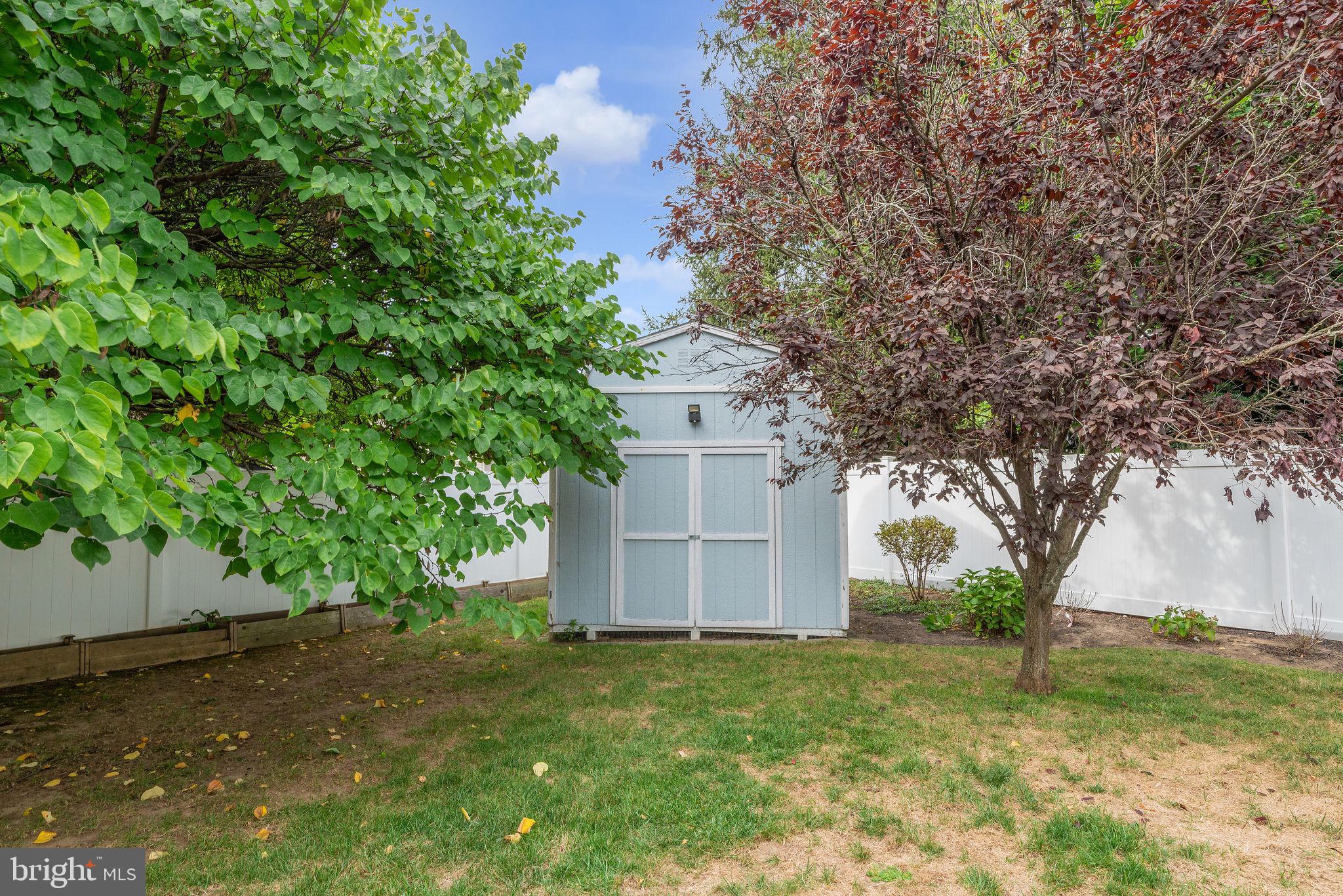 8 Dailey Drive Hamilton, NJ 08620 - Photo 42 of 46 a backyard of a house with plants and large tree
