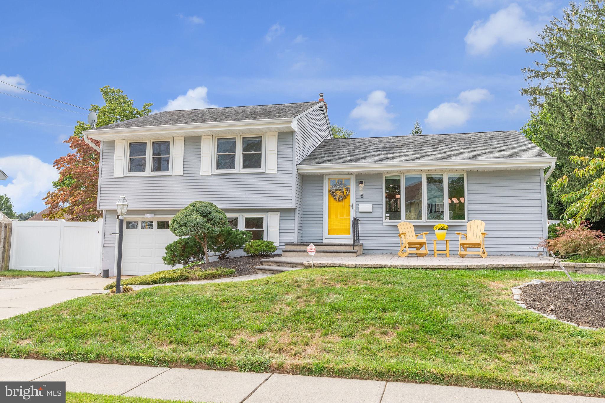 8 Dailey Drive Hamilton, NJ 08620 - Photo 5 of 46 a front view of a house with a yard table and chairs