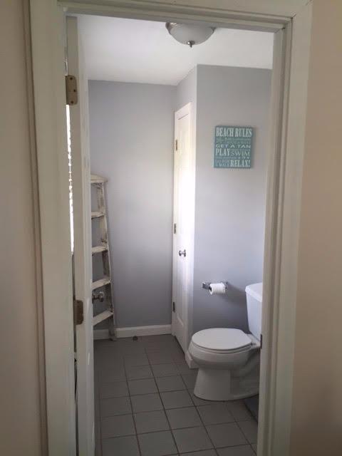 64 Edgewater Road Mashpee, MA 02649 - Photo 11 of 18 a white toilet sitting next to a bathroom sink