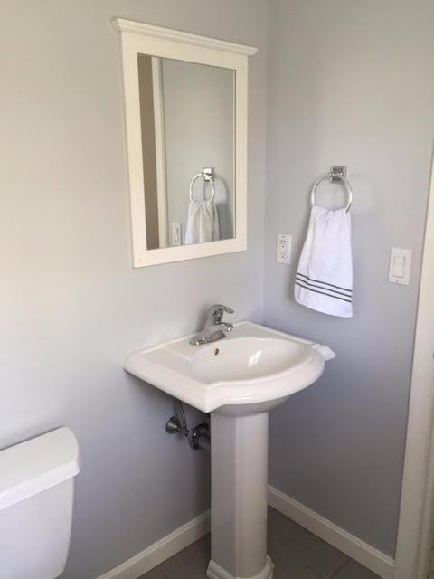 64 Edgewater Road Mashpee, MA 02649 - Photo 12 of 18 a bathroom with a toilet a sink and mirror