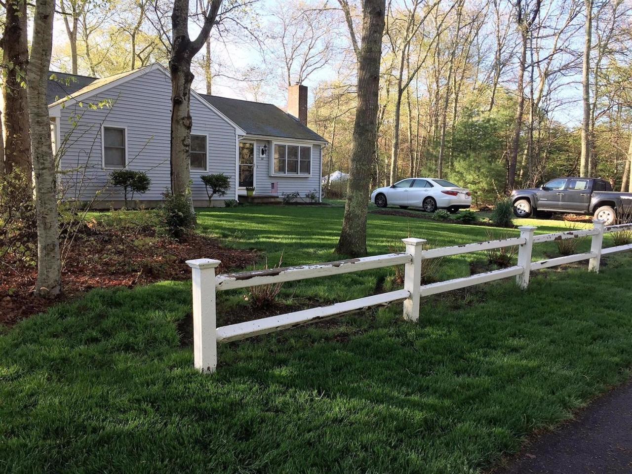 64 Edgewater Road Mashpee, MA 02649 - Photo 2 of 18 a view of a house with a yard and a large tree