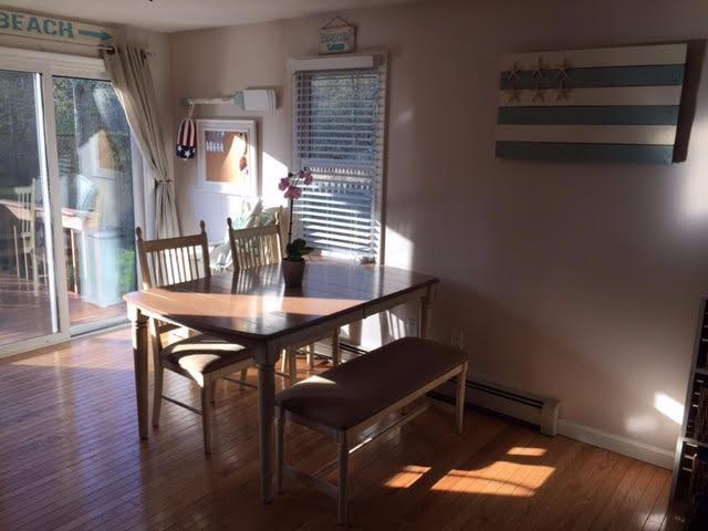 64 Edgewater Road Mashpee, MA 02649 - Photo 3 of 18 a view of a dining room with furniture and wooden floor