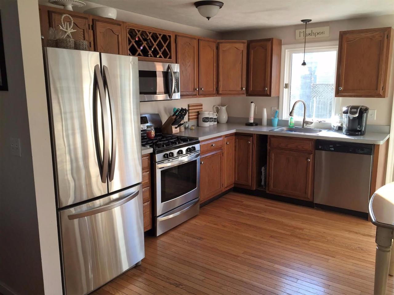 64 Edgewater Road Mashpee, MA 02649 - Photo 4 of 18 a kitchen with stainless steel appliances granite countertop a refrigerator stove and sink