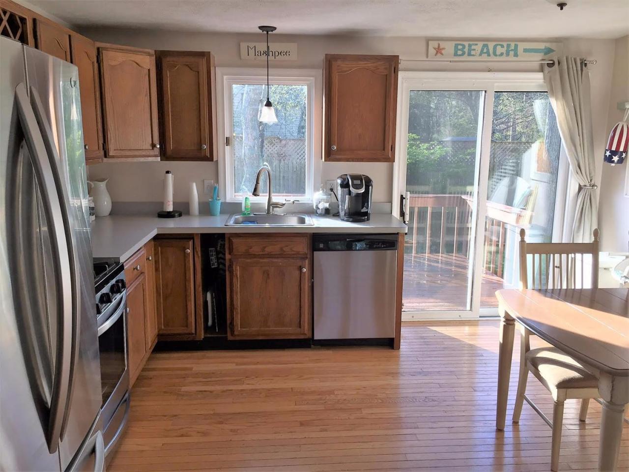 64 Edgewater Road Mashpee, MA 02649 - Photo 5 of 18 a kitchen with stainless steel appliances granite countertop a refrigerator a stove a sink and a window