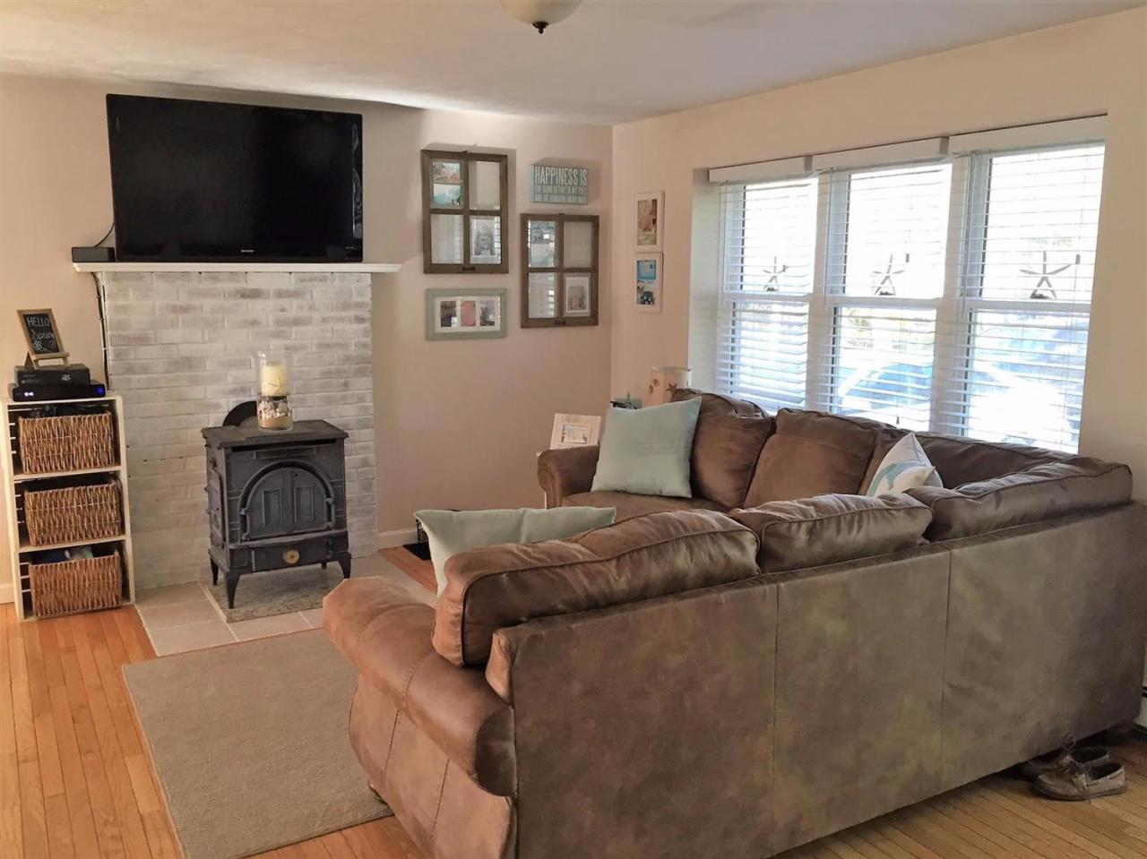 64 Edgewater Road Mashpee, MA 02649 - Photo 9 of 18 a living room with furniture fireplace and flat screen tv