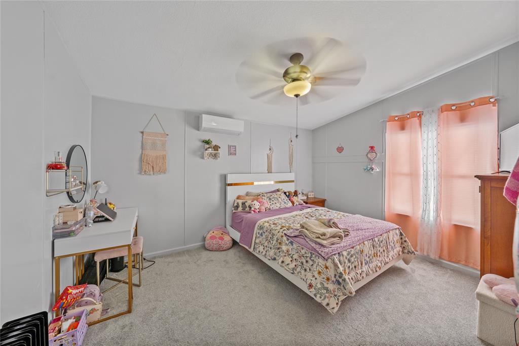 169 Cumberland Trail Bridgeport, TX 76426 - Photo 20 of 23 a bedroom with a bed and a chandelier