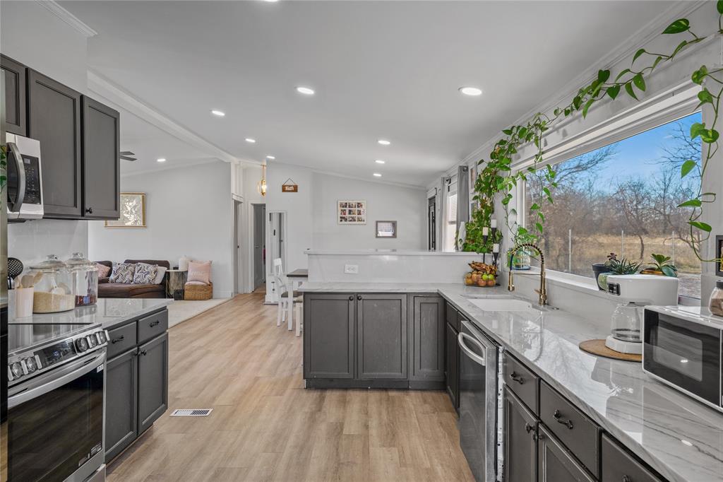169 Cumberland Trail Bridgeport, TX 76426 - Photo 2 of 23 a large kitchen with stainless steel appliances granite countertop a lot of counter space and wooden floor