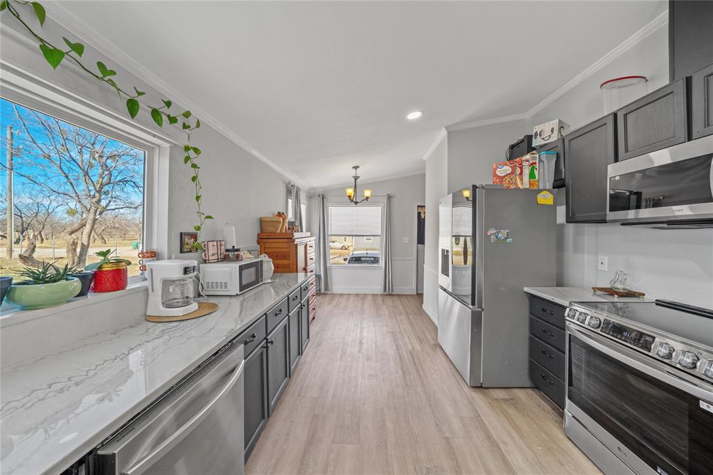 169 Cumberland Trail Bridgeport, TX 76426 - Photo 3 of 23 a kitchen with stainless steel appliances granite countertop a refrigerator stove and sink