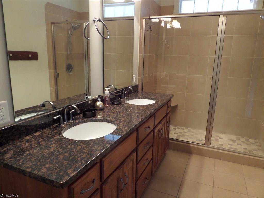 2050 Marina Pointe Road Salisbury, NC 28146 - Photo 11 of 23 Master bathroom has tile floors, granite counters, double sinks and a huge shower with a seat.