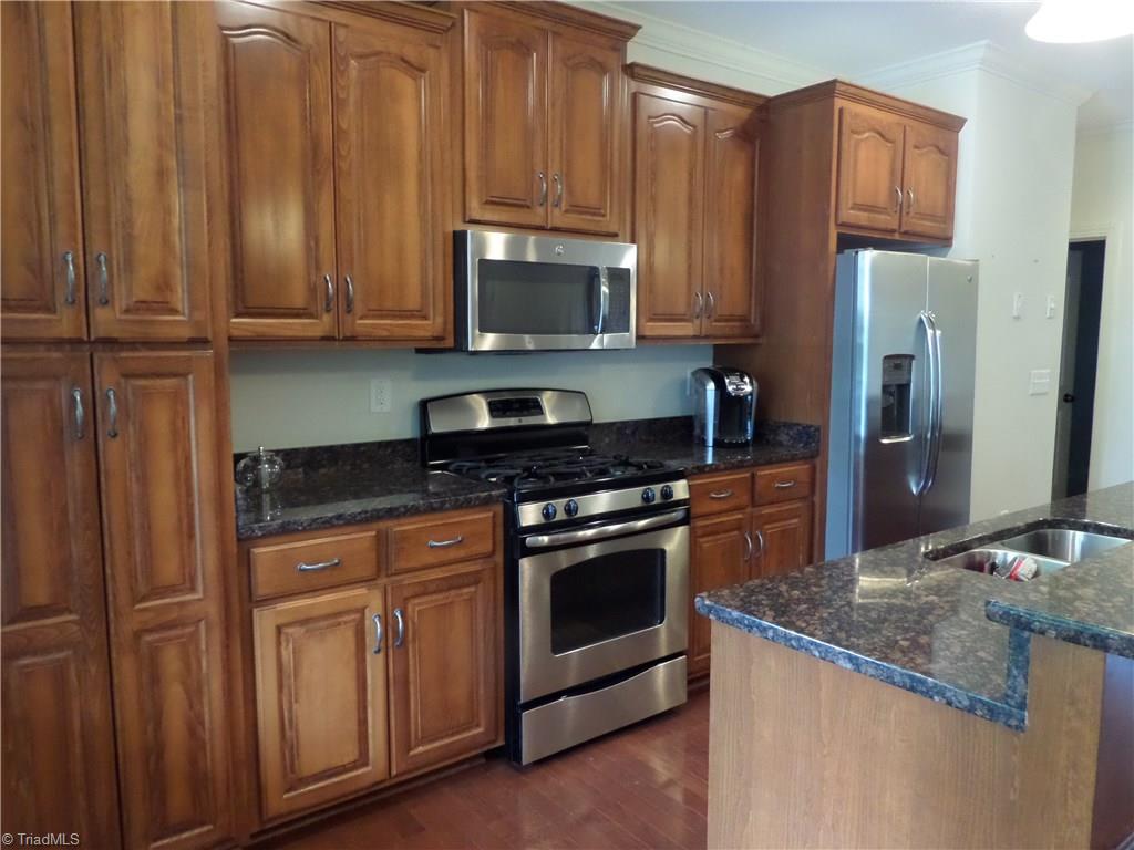 2050 Marina Pointe Road Salisbury, NC 28146 - Photo 6 of 23 Another view of the kitchen which has a gas stove, microwave and pantry cabinet to the left. Roll out drawers in the cabinets.