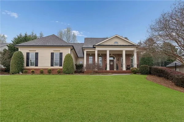 a front view of a house with a garden
