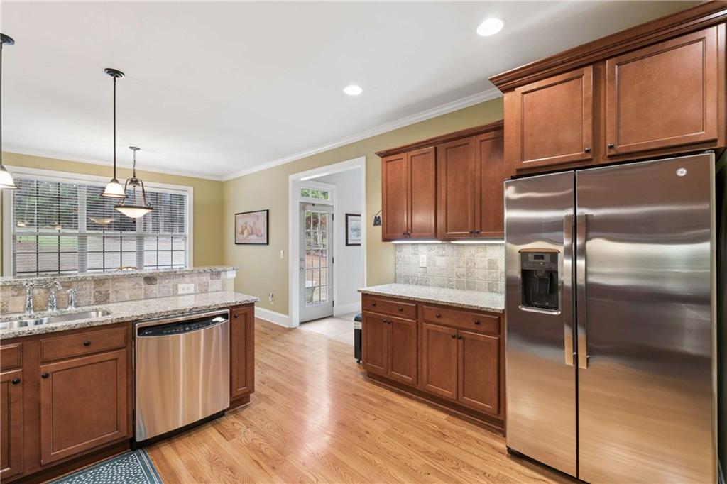 5148 Stefan Ridge Way Buford, GA 30519 - Photo 12 of 39 a kitchen with a refrigerator sink and cabinets