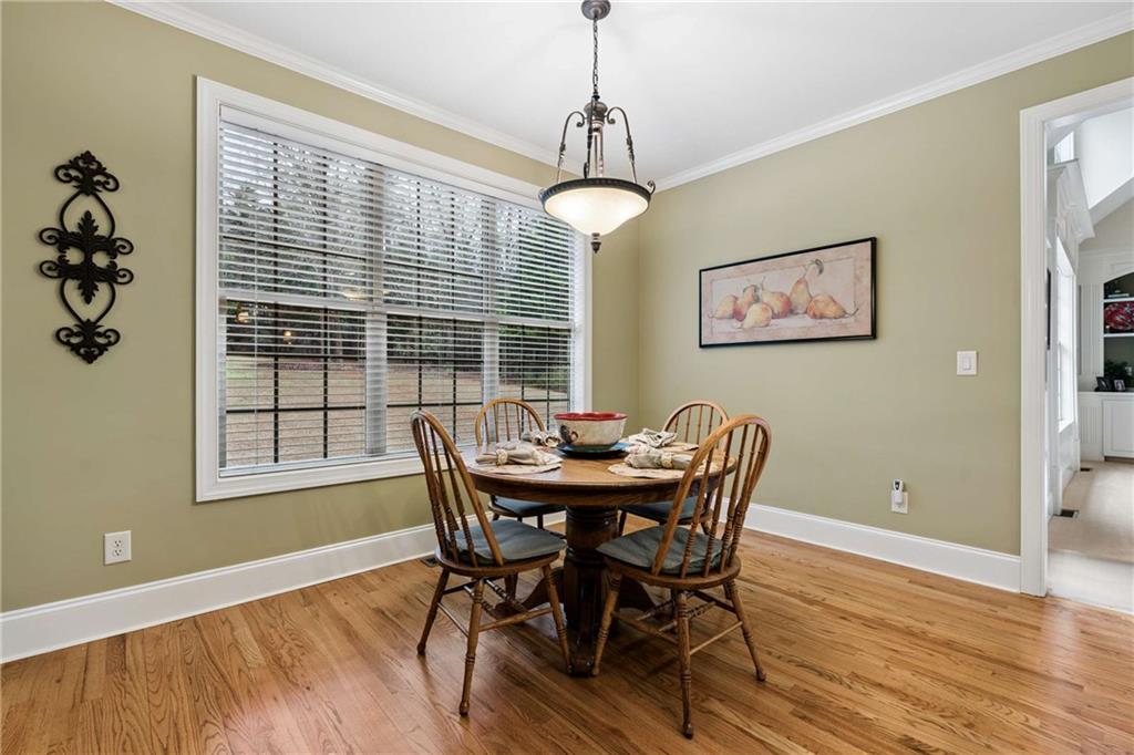 5148 Stefan Ridge Way Buford, GA 30519 - Photo 14 of 39 a view of a dining room with furniture window and wooden floor