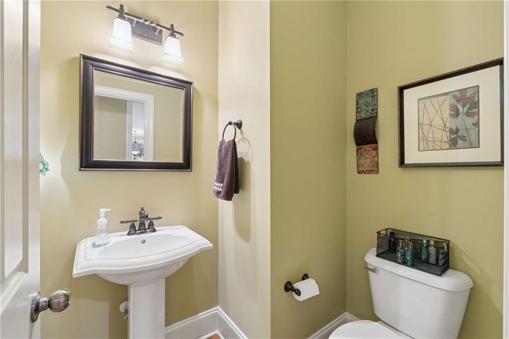 5148 Stefan Ridge Way Buford, GA 30519 - Photo 17 of 39 a bathroom with a toilet sink and mirror