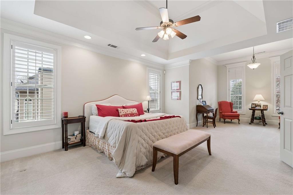 5148 Stefan Ridge Way Buford, GA 30519 - Photo 18 of 39 a bedroom with furniture and a chandelier