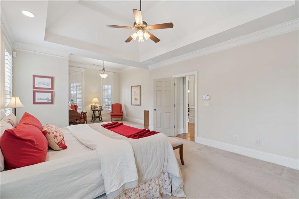 5148 Stefan Ridge Way Buford, GA 30519 - Photo 19 of 39 a bedroom with a bed and a chandelier